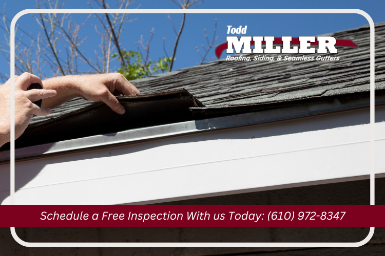 Easton roofing contractor doing an inspection on a house roof.