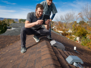 Todd Miller Roofing expert examining a Palmer Heights roof for pre-winter maintenance