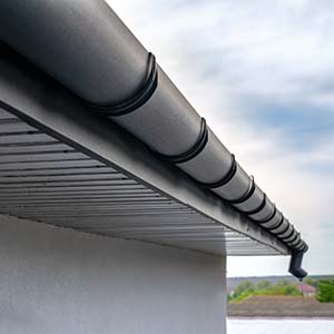 Todd Miller Roofing, Siding, and Seamless Gutters Gutters - click to view gutter styles and colors; close up of house with rounded black gutters